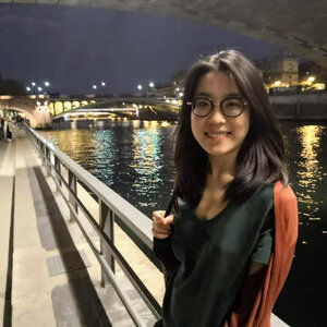 Portrait photo of Mia Yifan Yang with a river and a skyline of skyscrapers in the background